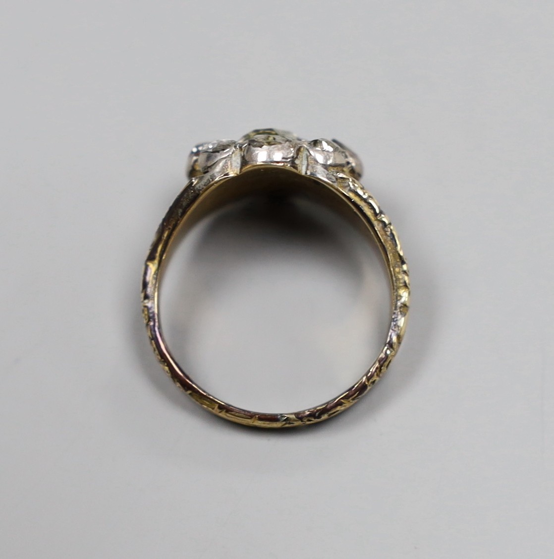 An early 19th century gold overlay and silver, rose diamond cluster ring, size P, gross 6.3 grams